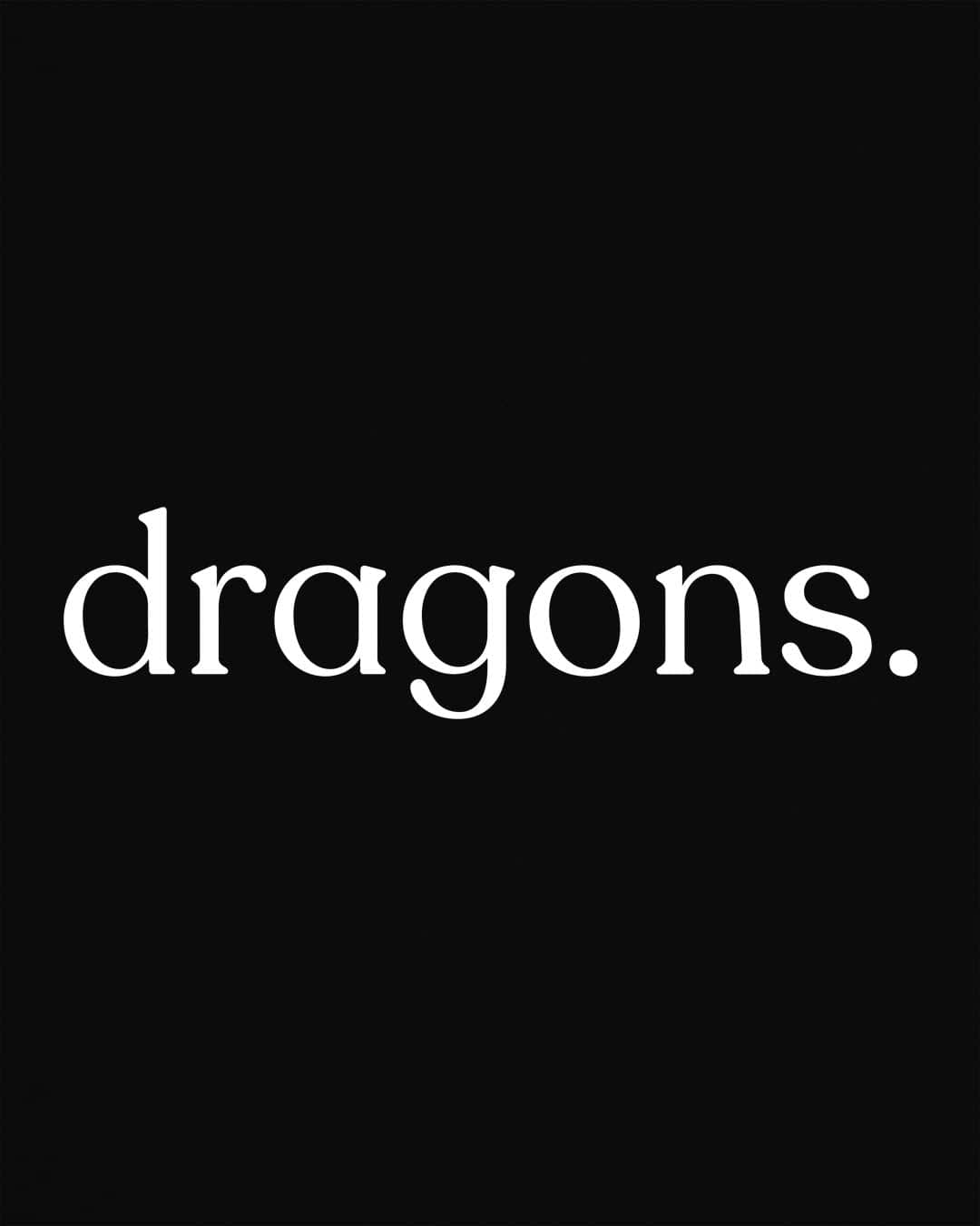 “dragons.” shirt in black, featuring minimalist lowercase text with a period in a clean serif font.