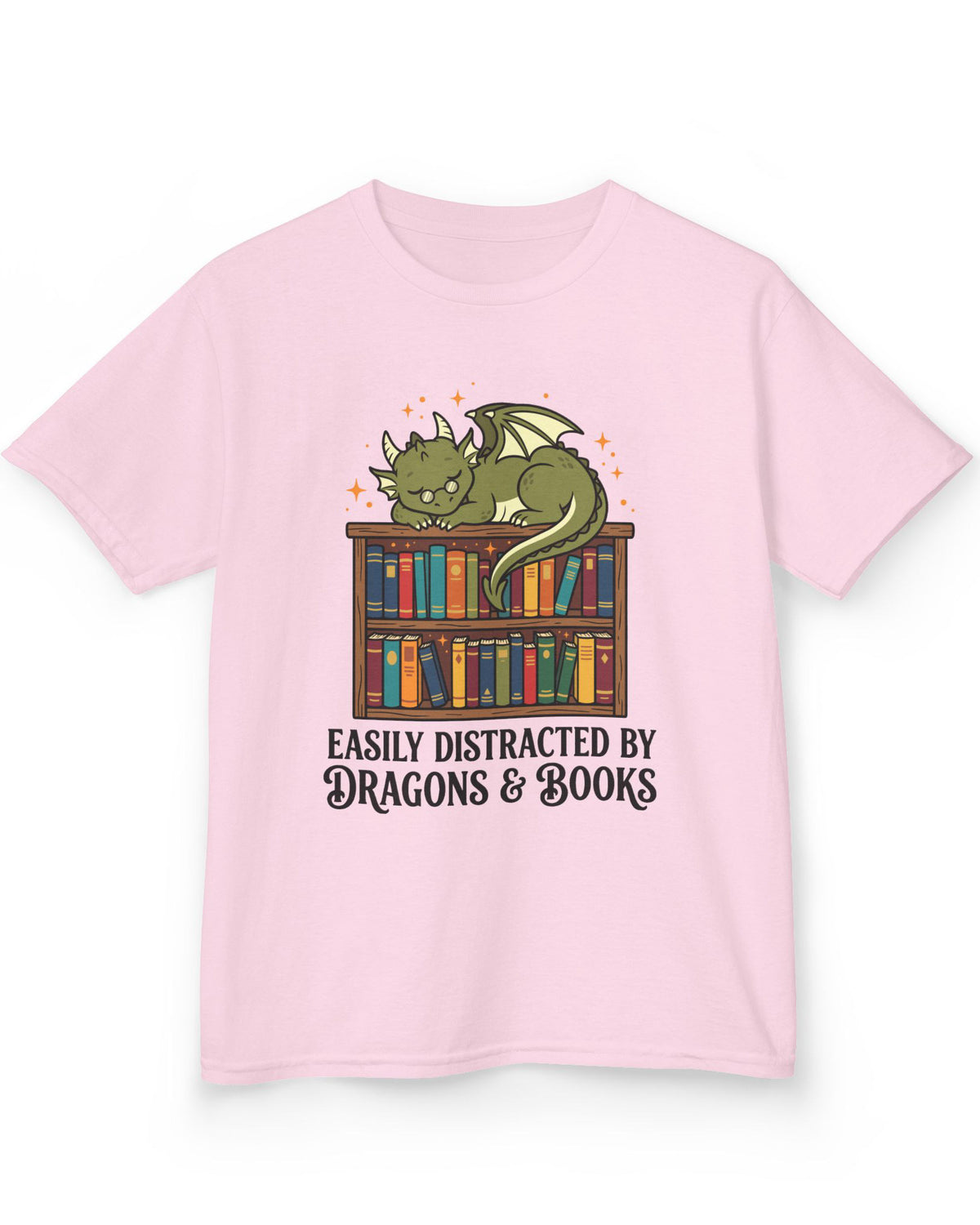 Easily Distracted by Dragons & Books shirt in light pink with a sleepy bookworm dragon lounging on a colorful bookshelf