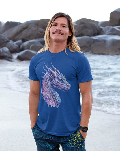 Man standing on a rocky beach wearing an Amethyst Nebula Dragon shirt featuring ethereal watercolor art of an aquatic dragon.