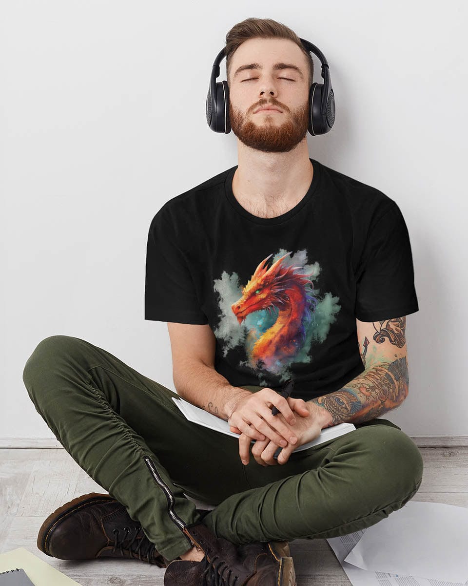 Man wearing headphones resting and wearing a Crimson Majestic Dragon shirt featuring ethereal watercolor art.