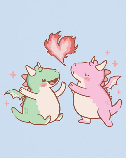 Love at First Flame shirt in light blue, featuring two cute dragons exchanging a heart-shaped flame.