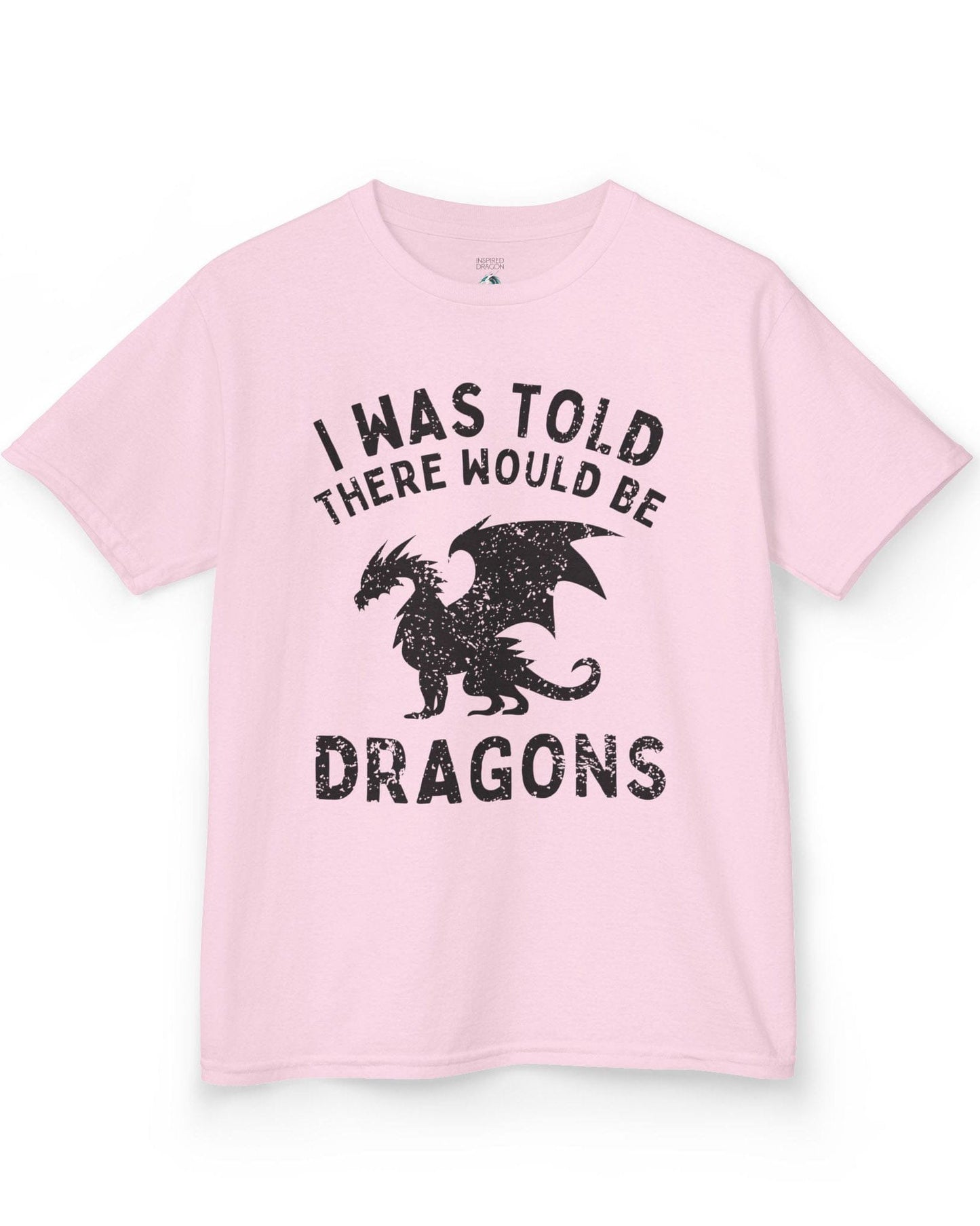 I Was Told There Would Be Dragons shirt in light pink, featuring distressed text and a bold dragon silhouette.
