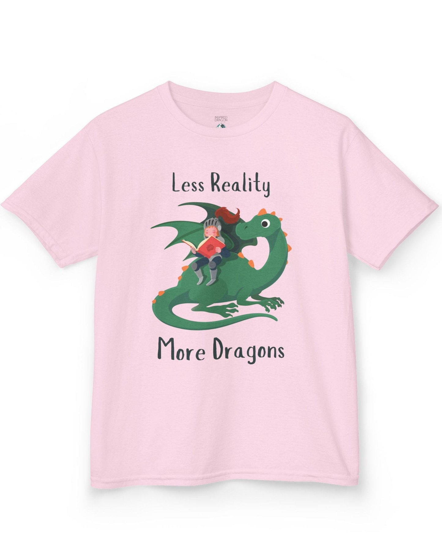 Less Reality, More Dragons shirt in light pink featuring a knight reading a book while riding a friendly green dragon.