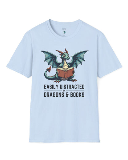 Easily Distracted by Dragons & Books shirt in light blue featuring a teal dragon reading an open book with wide eyes.

