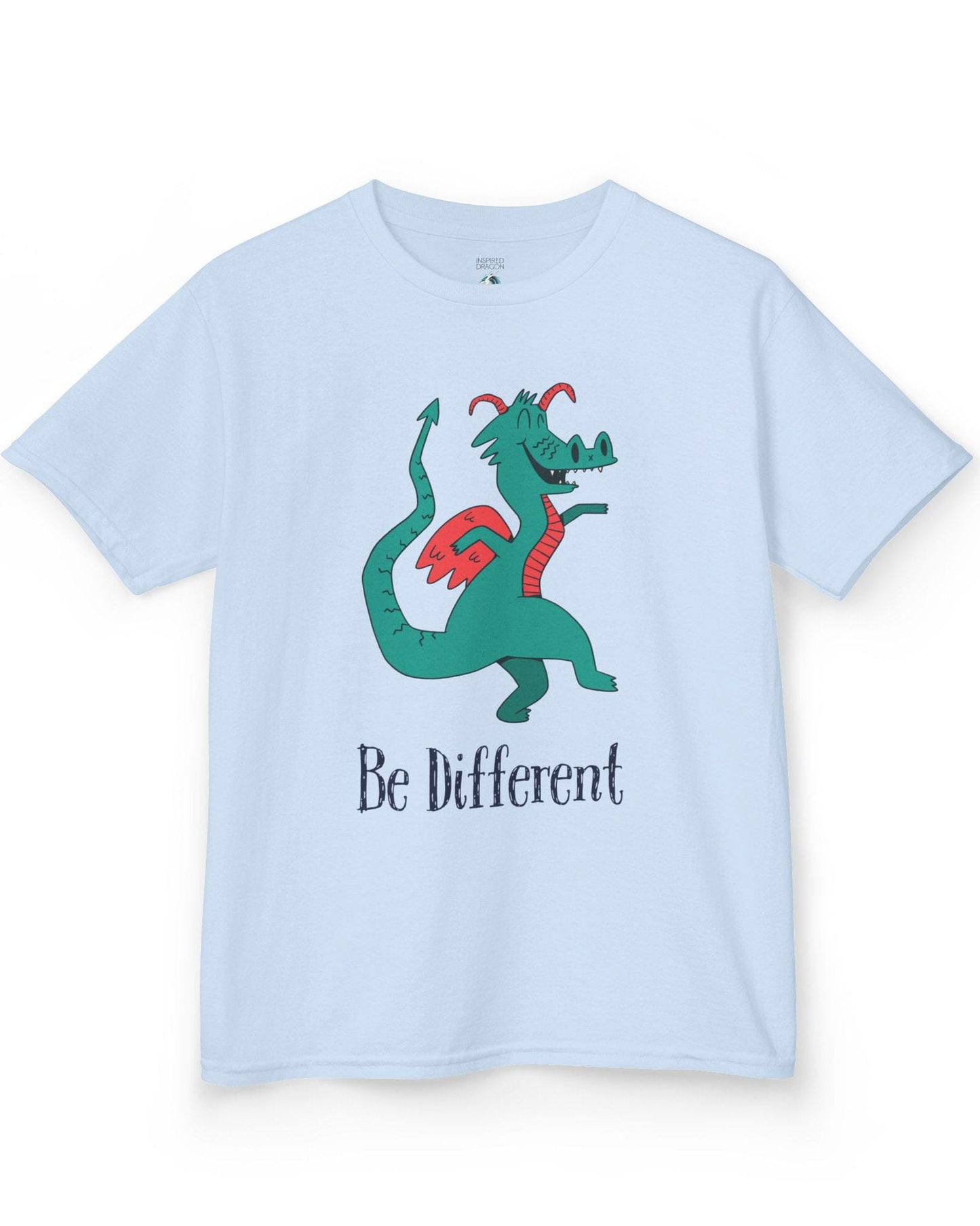 Be Different shirt in light blue featuring a quirky teal dragon with red wings dancing joyfully with text underneath.