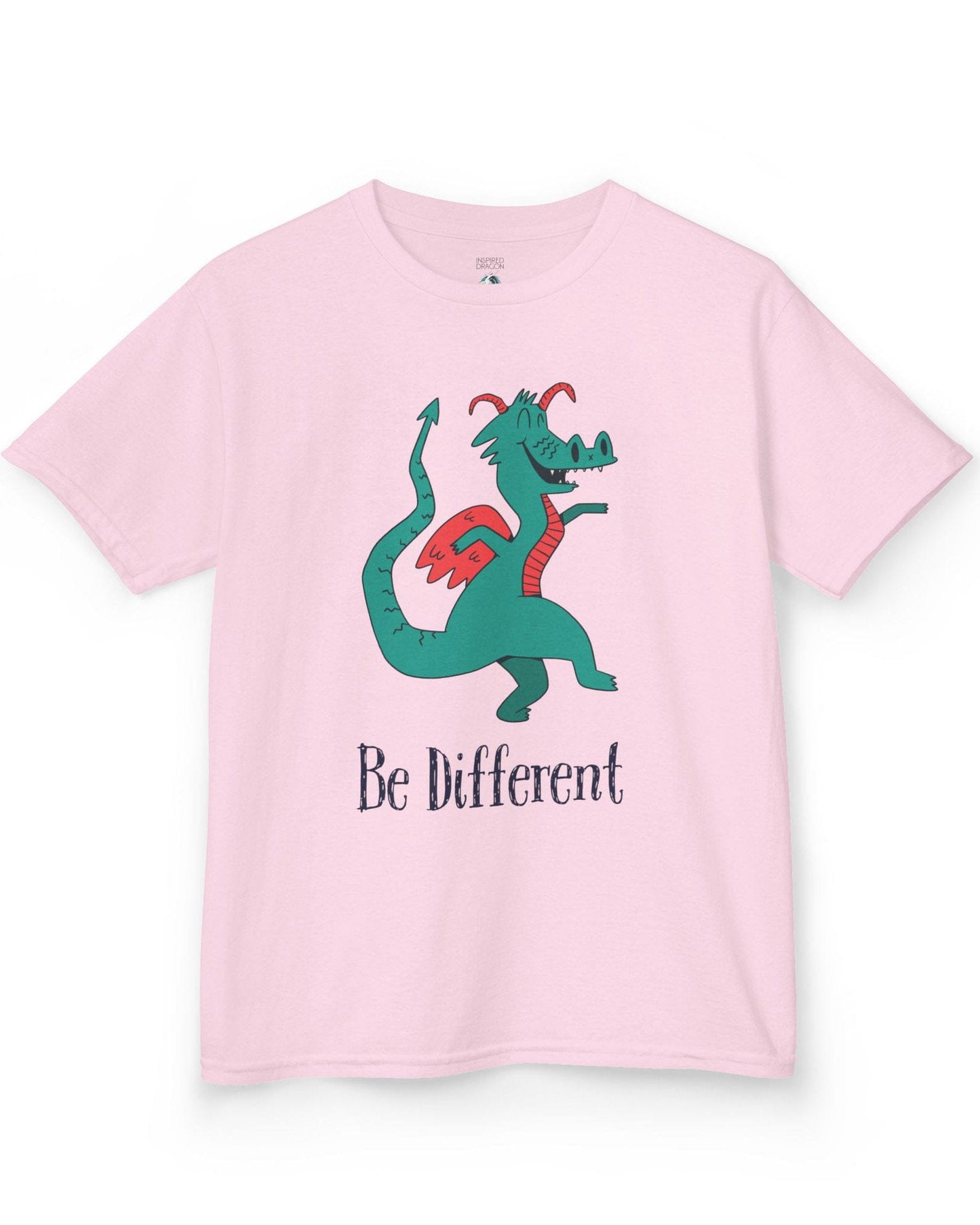 Be Different shirt in light pink featuring a quirky teal dragon with red wings dancing joyfully with text underneath.