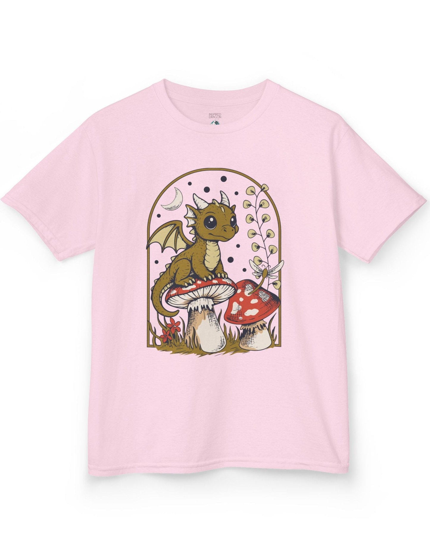 Moonlit Magic shirt in light pink featuring a wide-eyed dragon sitting on a mushroom beneath a crescent moon.