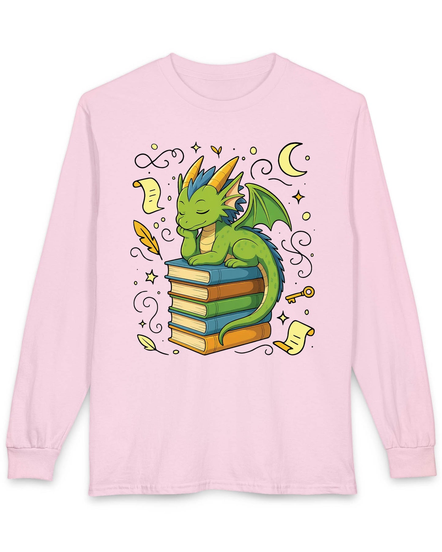 Enchanted Daydreamer shirt in light pink featuring a sleepy green dragon resting atop a stack of colorful books