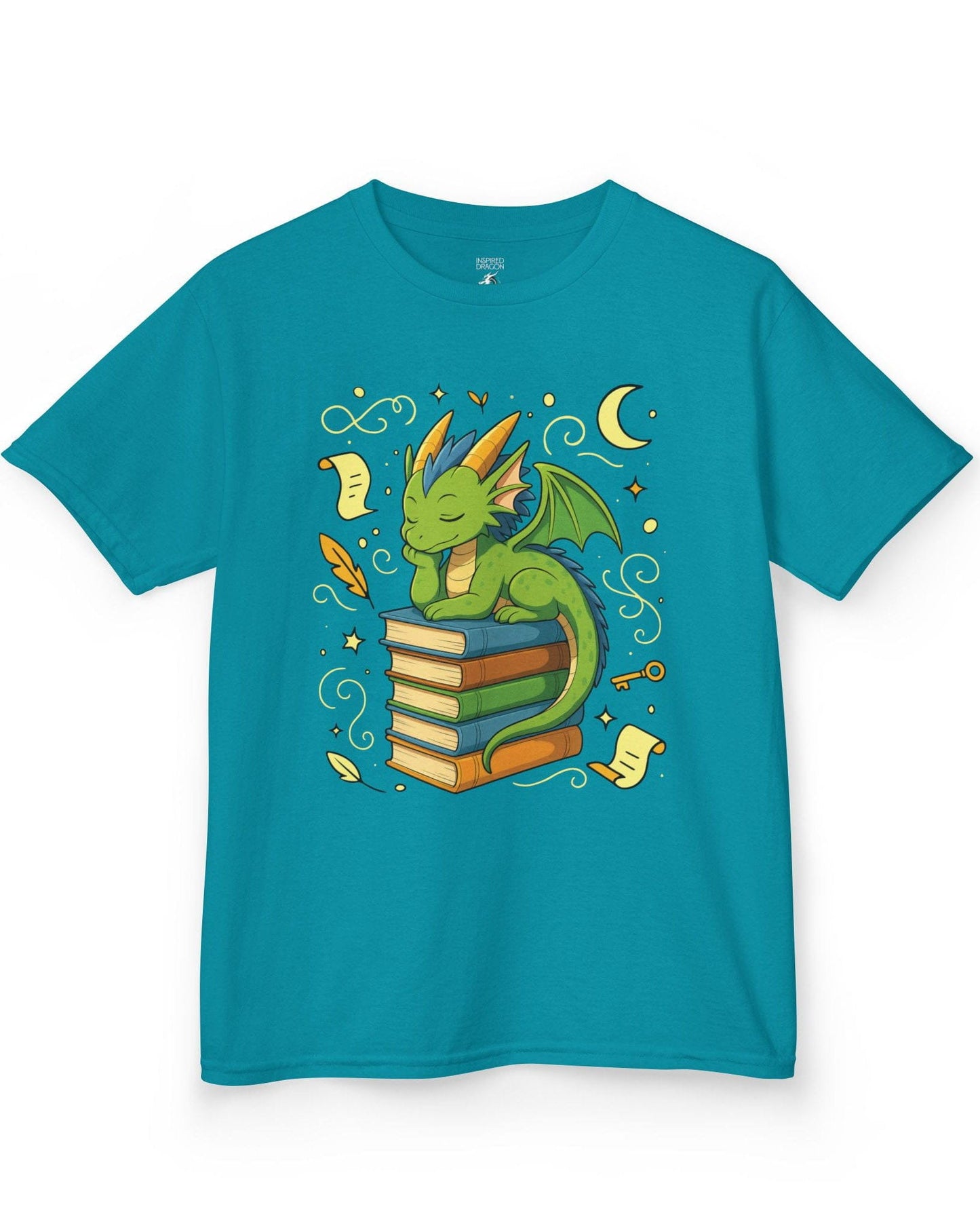 Enchanted Daydreamer shirt in tropical blue, featuring a sleepy green dragon resting atop a stack of colorful books.