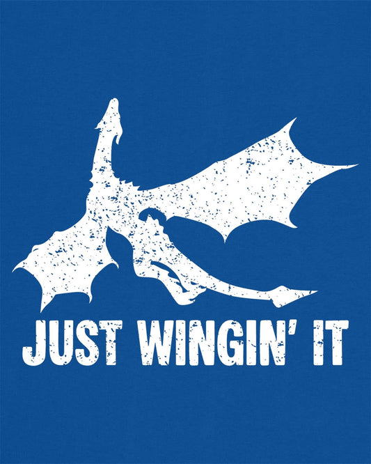 Just Wingin' It shirt in royal blue, featuring a distressed silhouette of a flying dragon above bold text.