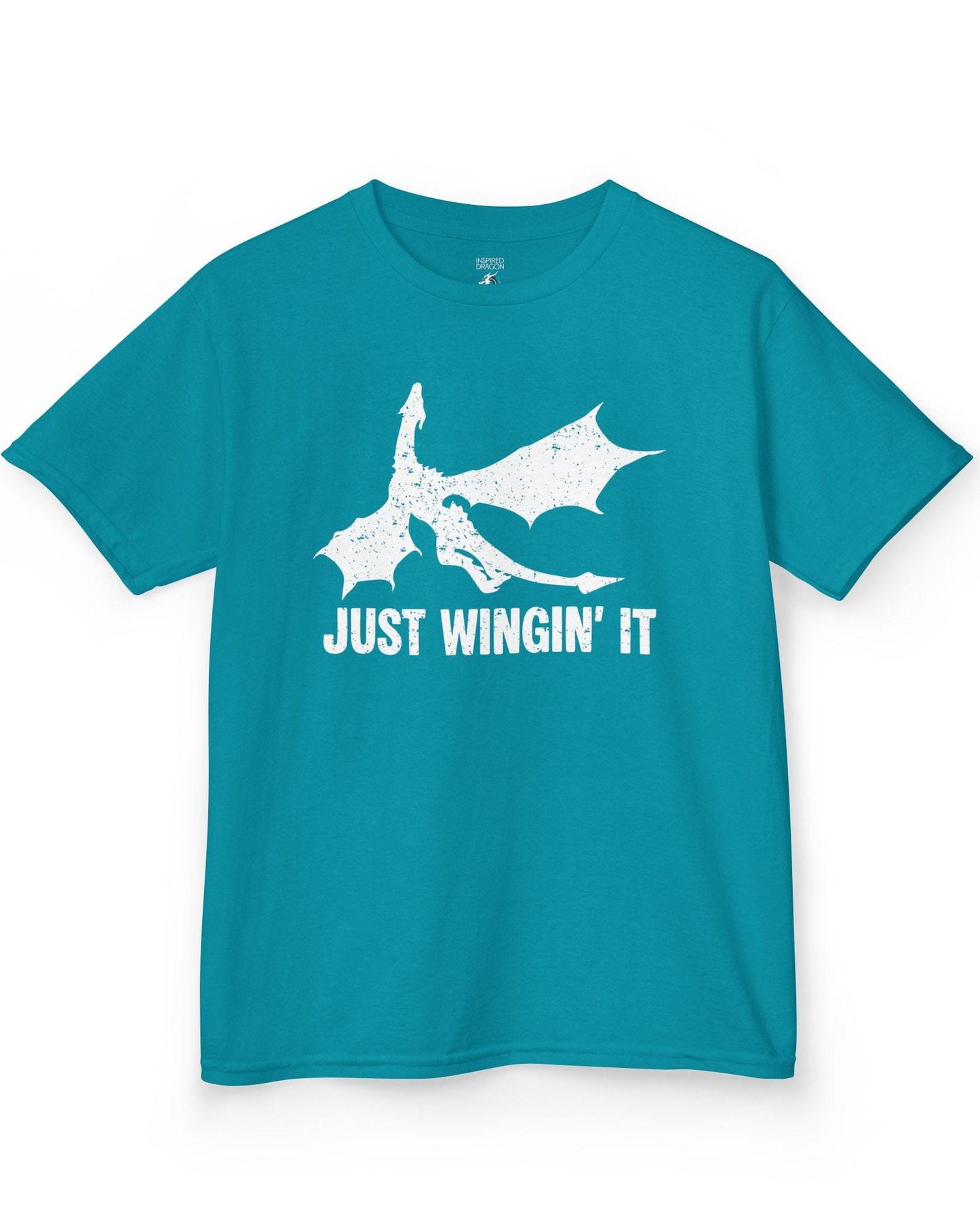Just Wingin' It shirt in tropical blue, featuring a distressed silhouette of a flying dragon above bold text.