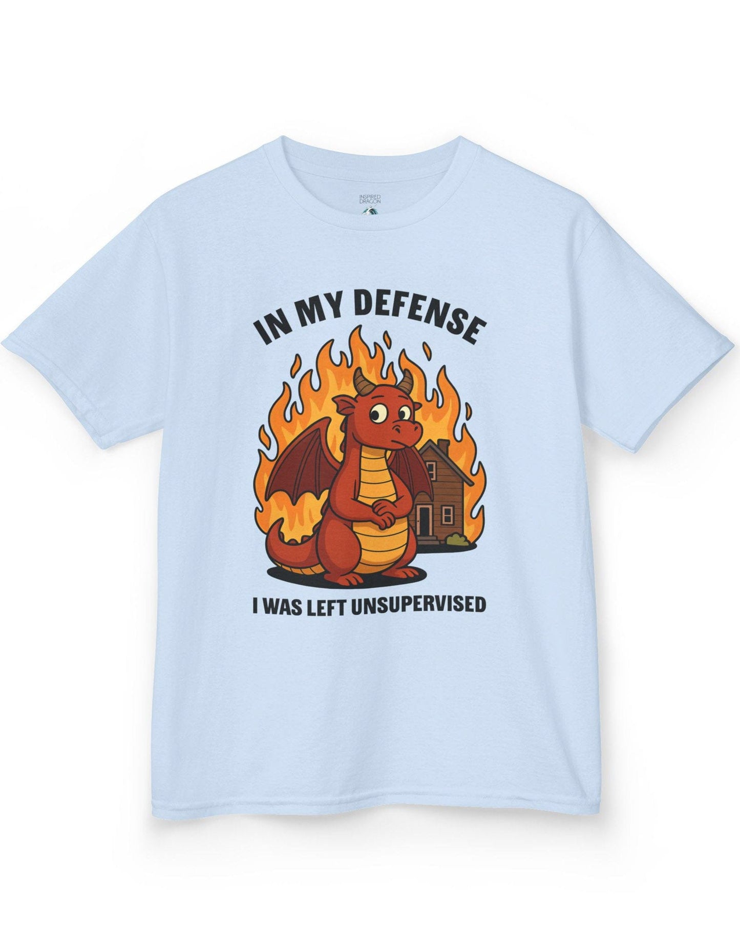 I Was Left Unsupervised shirt in light blue featuring a guilty-looking red dragon in front of a burning house.