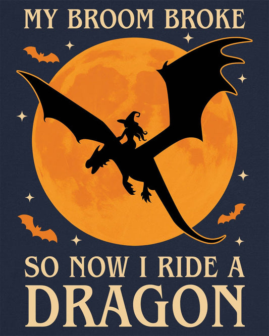 My Broom Broke shirt in navy featuring a witch riding a dragon across an orange full moon with bats.