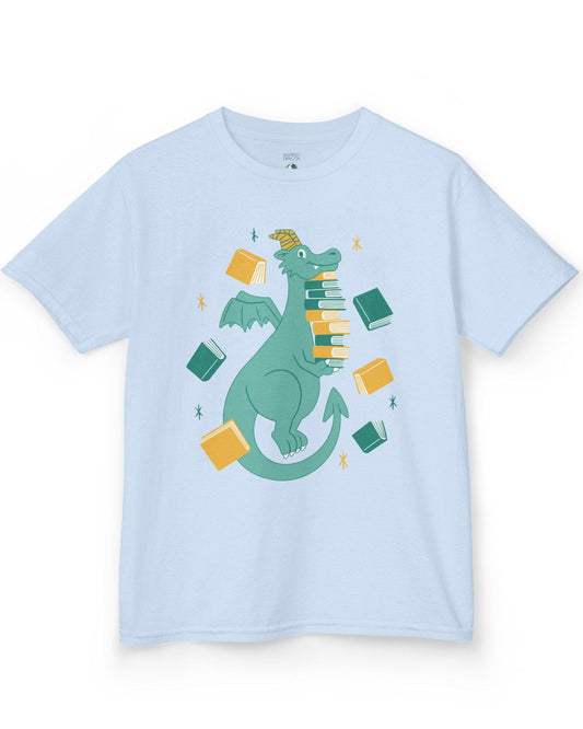 The Book Hoarder shirt in light blue featuring a cheerful teal dragon juggling a towering stack of books.