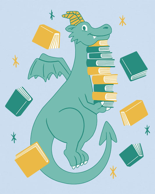 The Book Hoarder shirt in light blue featuring a cheerful teal dragon juggling a towering stack of books.