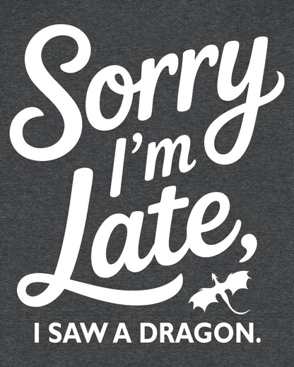 Sorry I'm Late shirt in dark heather grey featuring playful script typography and a small flying dragon icon.