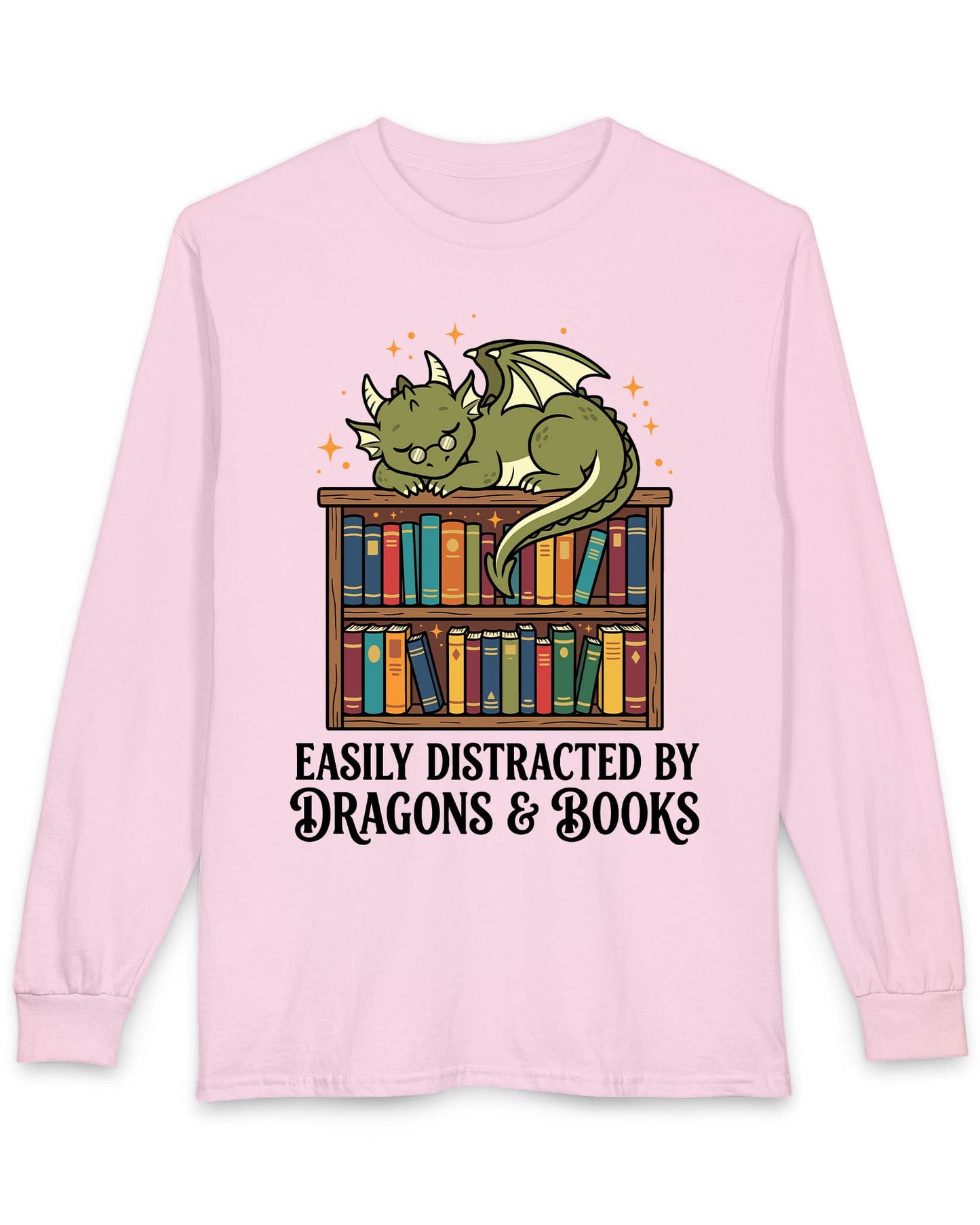 Easily Distracted by Dragons & Books shirt in light pink with a sleepy bookworm dragon lounging on a colorful bookshelf