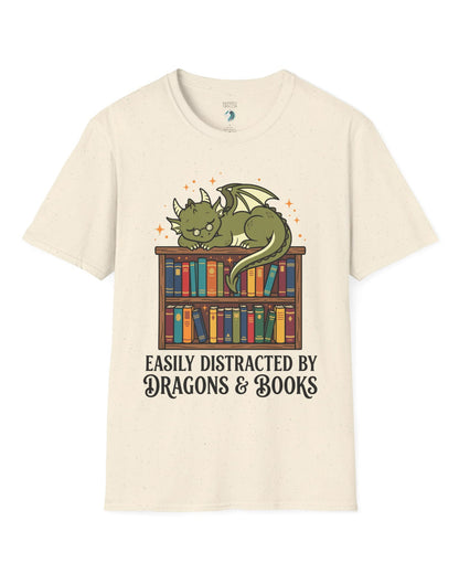 Easily Distracted by Dragons & Books shirt in natural with a sleepy bookworm dragon lounging on a colorful bookshelf
