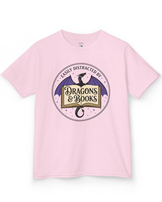 Easily Distracted shirt in light pink with a mystical dragon, open book, and cozy fantasy reader vibes