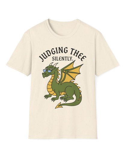 Judging Thee Silently shirt in natural featuring a judgmental green dragon with glasses, folded wings, and text