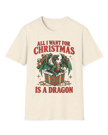 All I Want for Christmas shirt in natural featuring a green dragon emerging from a red and green wrapped gift box