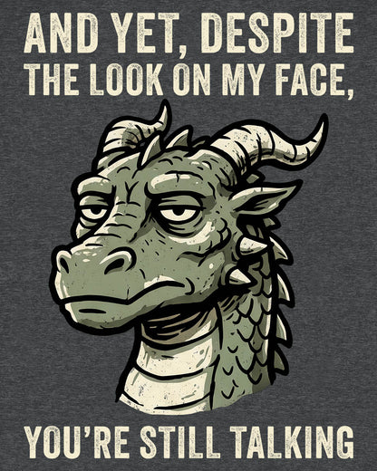 You're Still Talking shirt in dark heather featuring a weary green dragon and distressed text