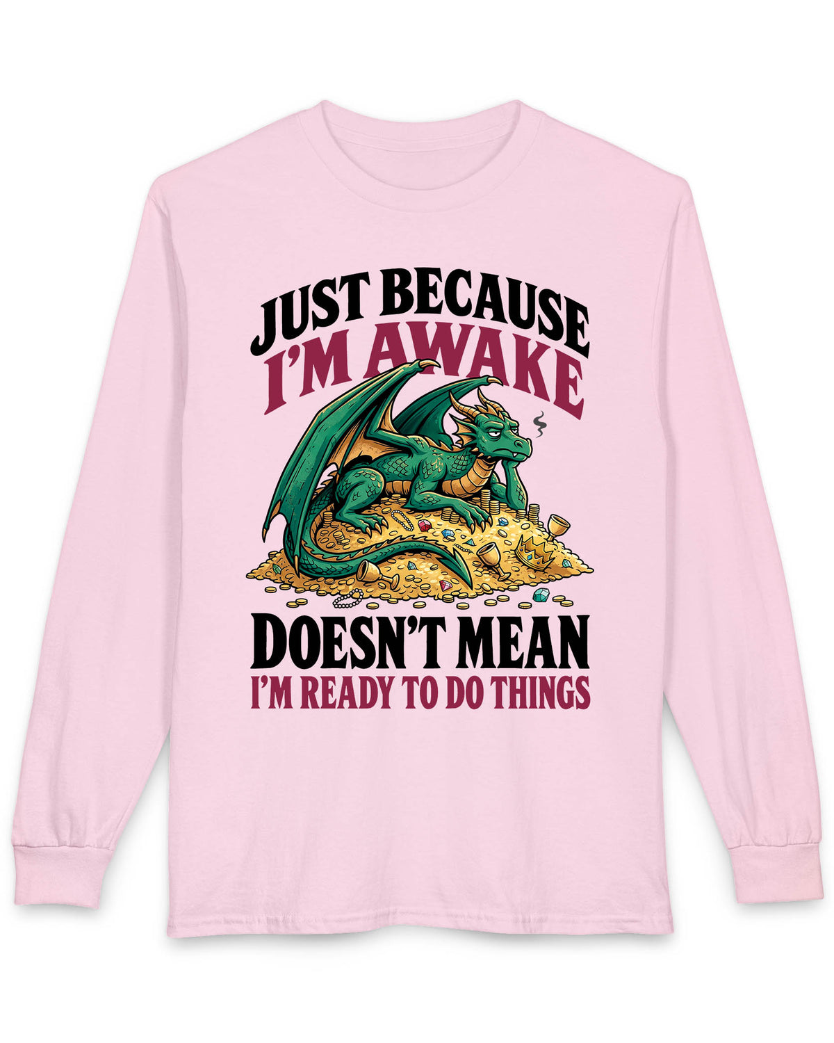 Just Because I'm Awake shirt in light pink featuring a sleepy green dragon lounging on a pile of gold beneath bold text