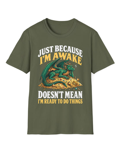 Just Because I'm Awake shirt in military green featuring a sleepy green dragon lounging on a pile of gold beneath bold text