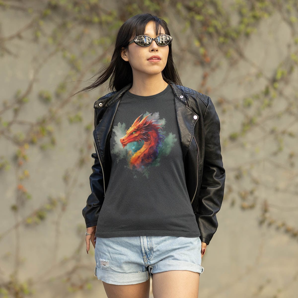 Woman in sunglasses outside wearing a leather jacket over a Western Dragon Shirt featuring ethereal watercolor art.