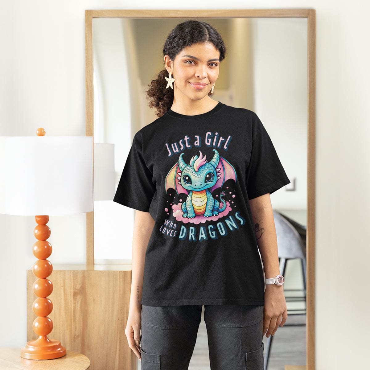 Woman wearing a Just a Girl Who Loves Dragons Shirt in black, featuring an adorable wide-eyed dragon in pastel colors.